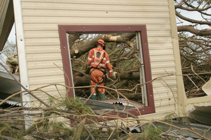 Image of rescue worker inspecting damage