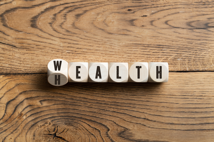 Concept of wealth health spelled out in letteredcubes